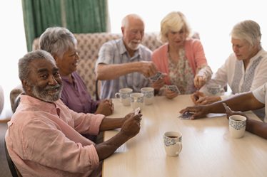 group of older adults playing cards